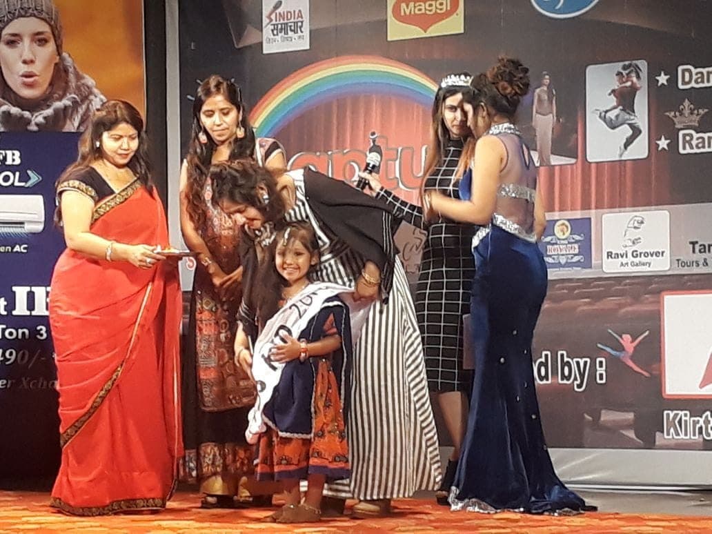 Junior students on a brightly lit stage during a show